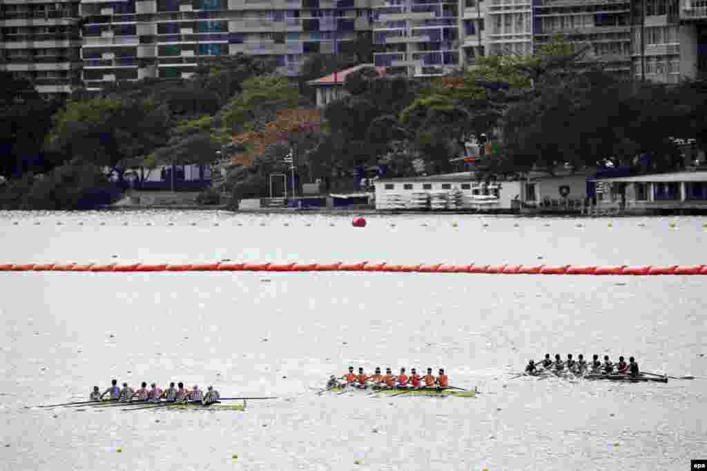 (Left to right:) Teams from the United States, the Netherlands, and New Zealand row in a men's coxed-eight race. 