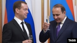 Russia - Russia's Prime Minister Dmitry Medvedev (L) and Armenia's Prime Minister Hovik Abrahamyan hold glasses of champagne during a ceremony of signing joint documents following Russian-Armenian talks, Yerevan, April 07, 2016