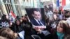 Armenians demonstrate outside the French Embassy in Yerevan to thank France for enacting a law that makes it a crime to deny the mass killings of Armenians