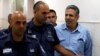 Gonen Segev, a former Israeli cabinet minister indicted on suspicion of spying for Iran, is escorted by prison guards as he arrives to court in Jerusalem, July 5, 2018 REUTERS/Ronen Zvulun