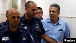 Gonen Segev, a former Israeli cabinet minister indicted on suspicion of spying for Iran, is escorted by prison guards as he arrives to court in Jerusalem, July 5, 2018 REUTERS/Ronen Zvulun