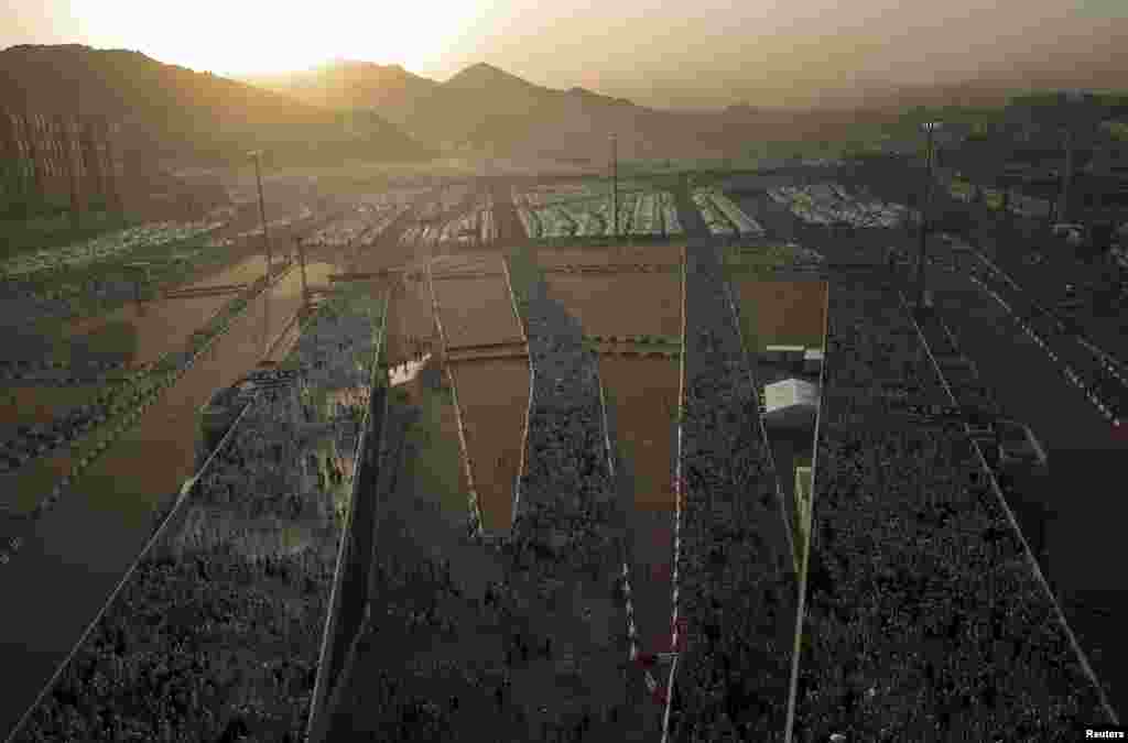 Muslim pilgrims walk on roads as they head to cast stones at pillars symbolizing Satan during the annual hajj pilgrimage in Mina on the first day of Eid al-Adha, near the holy city of Mecca, on September 24. (Reuters/Ahmad Masood)