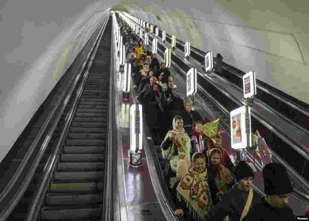 People in traditional costumes sing Christmas carols in the subway as they go to celebrate Orthodox Christmas on Independence Square in central Kyiv on January 7. (Reuters/Gleb Garanich)