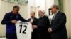 IRAN --Iranian President Hassan Rohani receives the team's home jersey from Iran's Portuguese head coach Carlos Queiroz (L) during a ceremony to bid farewell for the Iranian national team as they head to the 2018 FIFA World Cup finals in Russia, Tehran, M