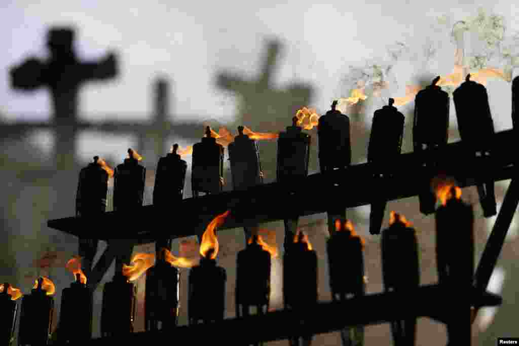 Torches are lit in front of Warsaw's Monument to the Fallen and Murdered in the East, during ceremonies commemorating the 75th anniversary of the Soviet Union's invasion of the eastern part of Poland at the outbreak of World War II. (Reuters/Kacper Pempel)