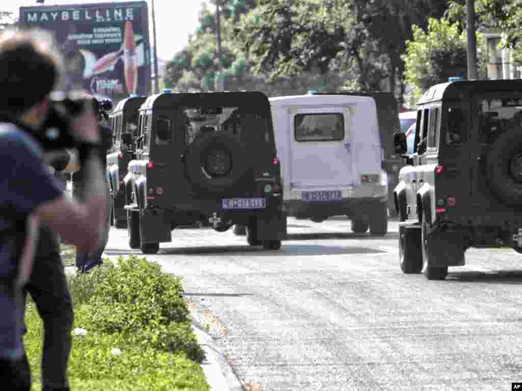 The white car car thought to be transporting Mladic from the Belgrade court to the airplane to take him to the Hague under heavy protection by Serbian security forces. AP photo by Vadim Ghirda