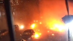 Surveillance footage shows vehicles parked on a street during an explosion from a Russian strike on Kharkiv on October 11.
