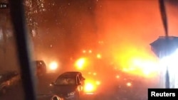 Surveillance footage shows vehicles parked on a street during an explosion from a Russian strike on Kharkiv on October 11.