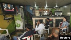 Libyans at a shop in Benghazi watch a television broadcast of U.S. President Barack Obama's May 19 speech on the Middle East.