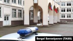 A police car stands outside a school in which a teenager fired shots and tossed smoke grenades, in Ivanteyevka, a town in the northeastern suburbs of Moscow, on September 5, 2017.