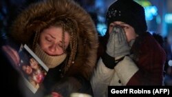 Mourners in Ontario, Canada, weep during a vigil for the victims of Ukrainian Airlines Flight PS752, which was shot down by Iran in 2020, killing all 176 people on board. 