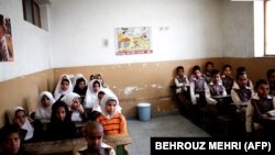 Afghan schoolchildren attend a class at the Shahid Nasseri refugee camp in Taraz Nahid village near the city of Saveh, some 130 kms southwest of the capital Tehran, on February 8, 2015.