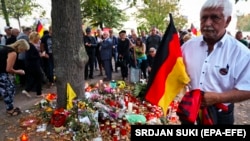 Right-wing protesters light candles during a protest in Koethen, Germany, on September 16.