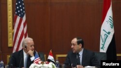 Iraqi Prime Minister Nuri al-Maliki (right) with U.S. Vice President Joe Biden in Baghdad on November 30.