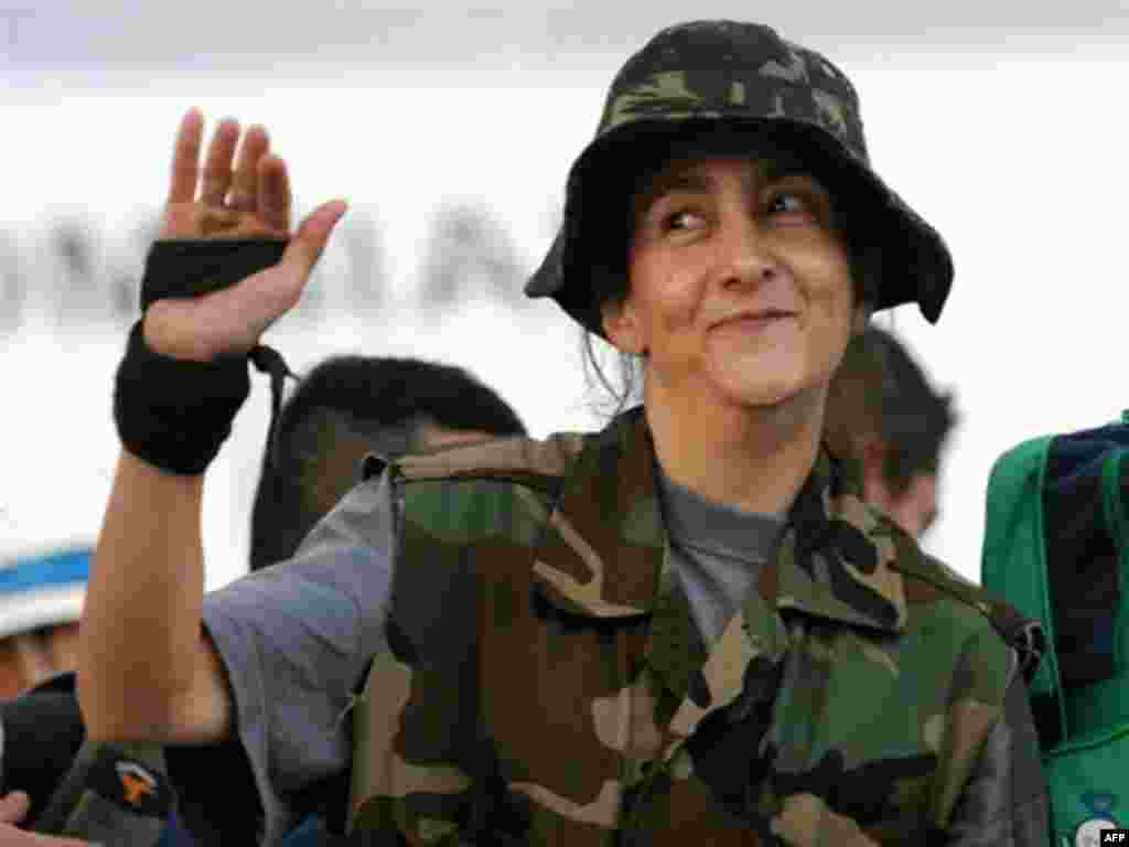 French-Colombian hostage Ingrid Betancourt , three U.S. nationals, and 11 soldiers rescued from Colombia's FARC - French-Colombian hostage Ingrid Betancourt waves upon her arrival at the Catam air base in Bogota on July 2, 2008. Betancourt along with three US nationals and 11 other FARC hostages were released from their captivity by the Colombian Army. 