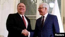 Polish Foreign Minister Jacek Czaputowicz and U.S. Secretary of State Mike Pompeo shake hands at a news conference at Lazienki Palace in Warsaw, Poland February 12, 2019. REUTERS/Kacper Pempel