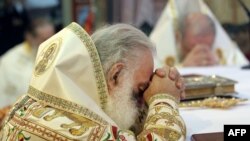 Greece -- Religious Orthodox Christians leaders pray inside a church in Heraklion on the Greek island of Crete, June 19, 2016