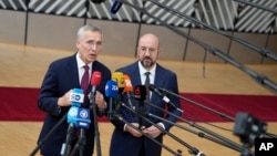 NATO Secretary-General Jens Stoltenberg (left) and European Council President Charles Michel speak with the media as they arrive for the EU summit in Brussels on June 29, with the Ukraine war top of the agenda.