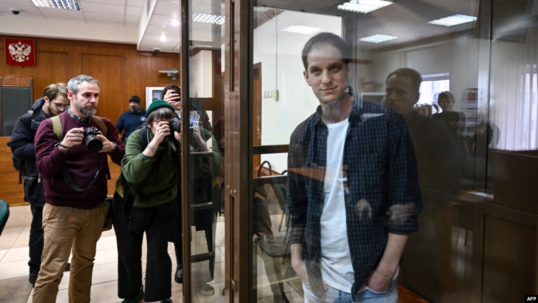 U.S. journalist Evan Gershkovich, arrested on espionage charges, stands inside a defendants' cage at the Moscow City Court on October 10.