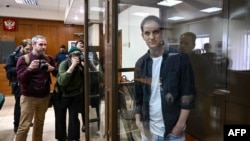 U.S. journalist Evan Gershkovich, arrested on espionage charges, stands inside a defendants' cage at the Moscow City Court on October 10.