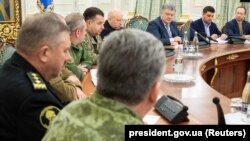 Ukrainian President Petro Poroshenko (third from right) chairs a meeting with members of the National Security Council in Kyiv on November 26.