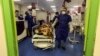 A medic moves a patient in a ward dedicated to people infected with the coronavirus at Forqani Hospital in Qom, the most affected region in Iran, on February 26.