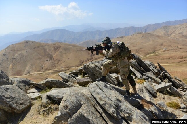 Afghan resistance movement and anti-Taliban uprising forces patrol on a hilltop in the Darband area of the Anaba district, Panjshir Province, in September.