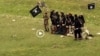 Grab from a video that shows militants loyal to the Islamic State (IS) blowing up bound and blindfolded Afghan prisoners with explosives. The victims were from Nangarhar province.