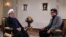 Iranian President Hassan Rouhani (L) gives a televised interview in Tehran, January 22, 2018