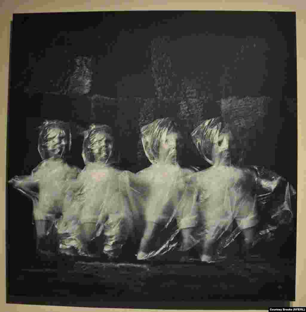 Four dolls are wrapped in plastic bags.