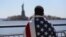 An immigrant looks toward New York's Statue of Liberty during a march for immigration reform in April.