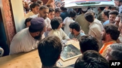 People carry the coffin of former Senator Hidayatullah Khan to an ambulance after he was killed in a bomb explosion in the Bajaur district of Pakistan's Khyber Pakhtunkhwa Province on July 3.