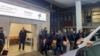 Family members and relatives gather at the general hospital in the Kosovar city of Peja after a gunman opened fire on a bus carrying teenagers near the village of Glodjane on November 26, killing at least three people. 