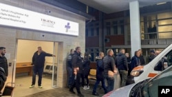 Family members and relatives gather at the general hospital in the Kosovar city of Peja after a gunman opened fire on a bus carrying teenagers near the village of Glodjane on November 26, killing at least three people. 