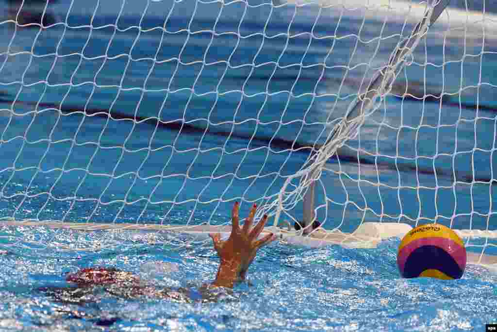 Edina Gangl of Hungary gestures after stopping a shot on goal during the women&#39;s water polo quarterfinal.