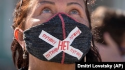 A woman wears a face mask with the message "No To Putin" during a protest against the constitutional amendments in St. Petersburg on July 1.