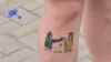 BELARUS -- A woman with a tattoo on her leg reading "Flowers are better than bullets" attends a protest against police violence during recent rallies of opposition supporters, who accuse strongman Alexander Lukashenko of falsifying the polls in the presid