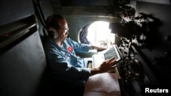 A Vietnamese military officer works within a Vietnamese air force AN-26 during a mission to find the missing Malaysia Airlines flight MH370 off Tho Chu islands on March 11.