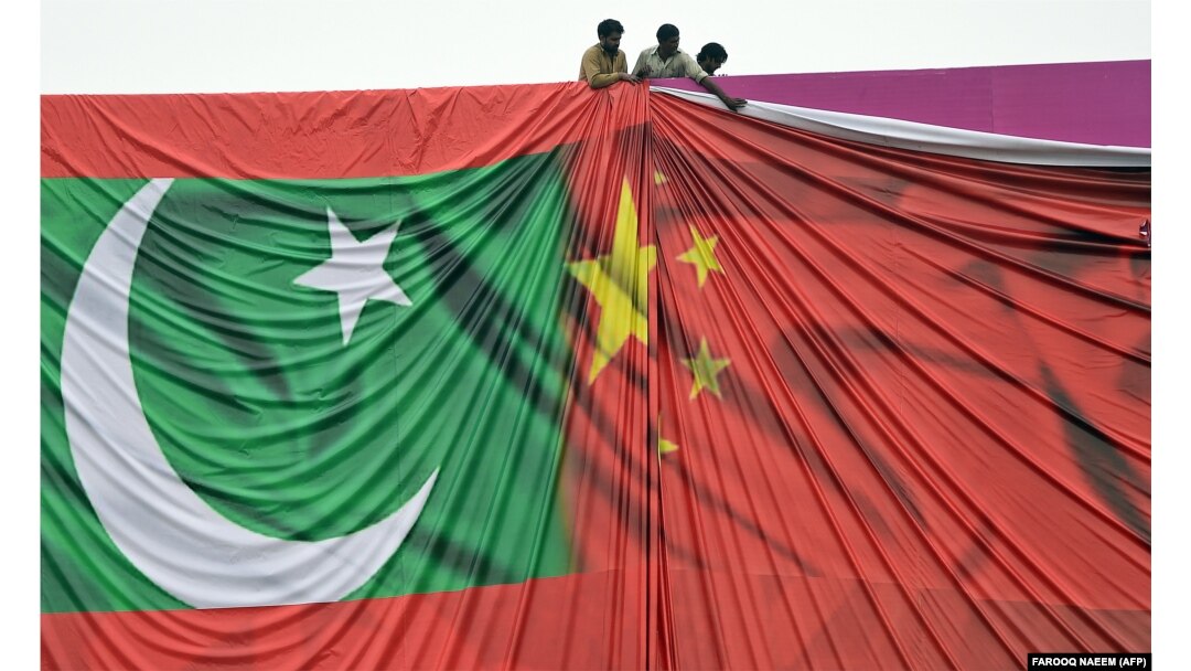 Pakistani workers arrange a welcome billboard with the Chinese and Pakistani flags ahead of a state visit by Chinese President Xi Jinping to Pakistan in 2015.