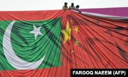 Pakistani workers arrange a welcome billboard with the Chinese and Pakistani flags ahead of a state visit by Chinese President Xi Jinping to Pakistan in 2015.