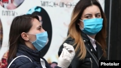 Armenia -- Masked pedestrians on the streets of Yerevan, March 17, 2020.