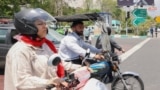 A man and a woman ride their motorcycles in central Tehran. (file photo)