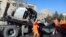 Afghan security personnel and municipality workers remove a damaged vehicle after a roadside bomb in Kabul on December 22.