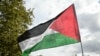 A protester waves a Palestinian flag during a march asking for the "recognition of the State of Palestine and the end of the genocide", in Paris on September 21, 2025.