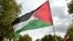 A protester waves a Palestinian flag during a march asking for the "recognition of the State of Palestine and the end of the genocide", in Paris on September 21, 2025.