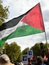 A protester waves a Palestinian flag during a march asking for the "recognition of the State of Palestine and the end of the genocide", in Paris on September 21, 2025.