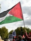 A protester waves a Palestinian flag during a march asking for the "recognition of the State of Palestine and the end of the genocide", in Paris on September 21, 2025.