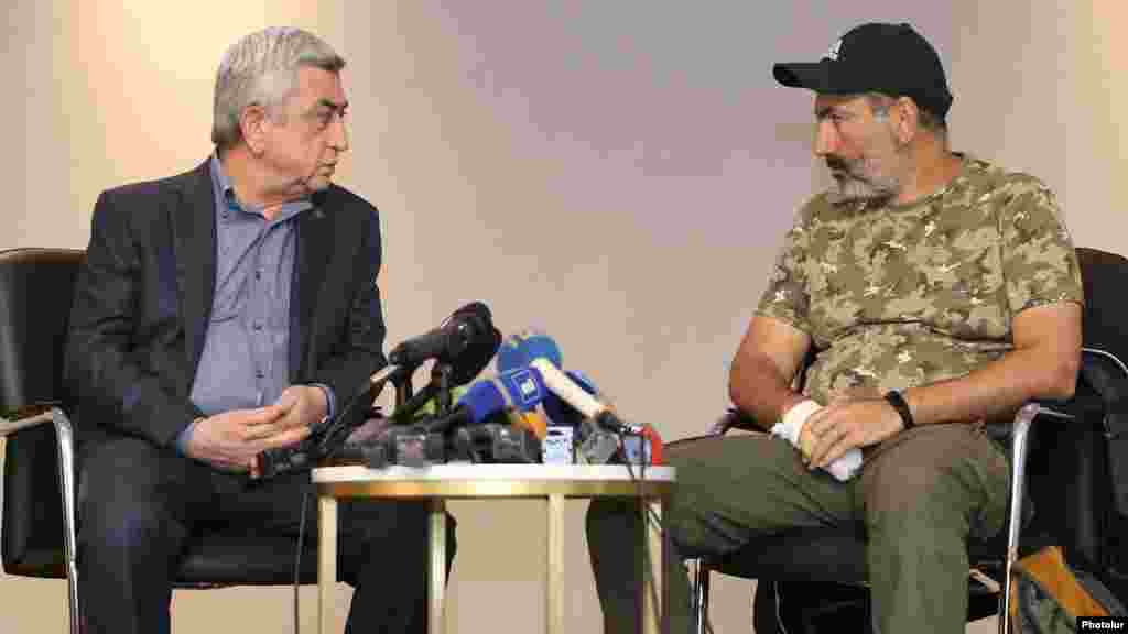 Prime Minister Serzh Sarkisian (left) and opposition leader Nikol Pashinian meeting lasted three minutes, reporters present said.