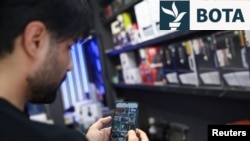 Një iranian duke përdorur telefonin e tij pasi autoritetet rikthyen qasjen në internet. Tehera, 27 maj 2026.