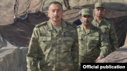 Azerbaijan - President Ilham Aliyev and Defense Minister Zakir Hasanov (C) visit Azerbaijani troops in Agdam district, 6Aug2014.